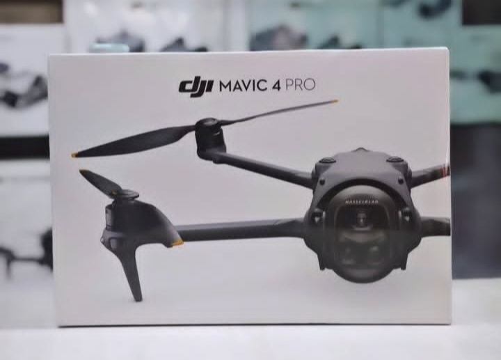 A product box for a DJI Mavic 4 Pro drone is shown centered. The white packaging features the black drone against a plain background, with the product name and company logo printed in black text at the top.